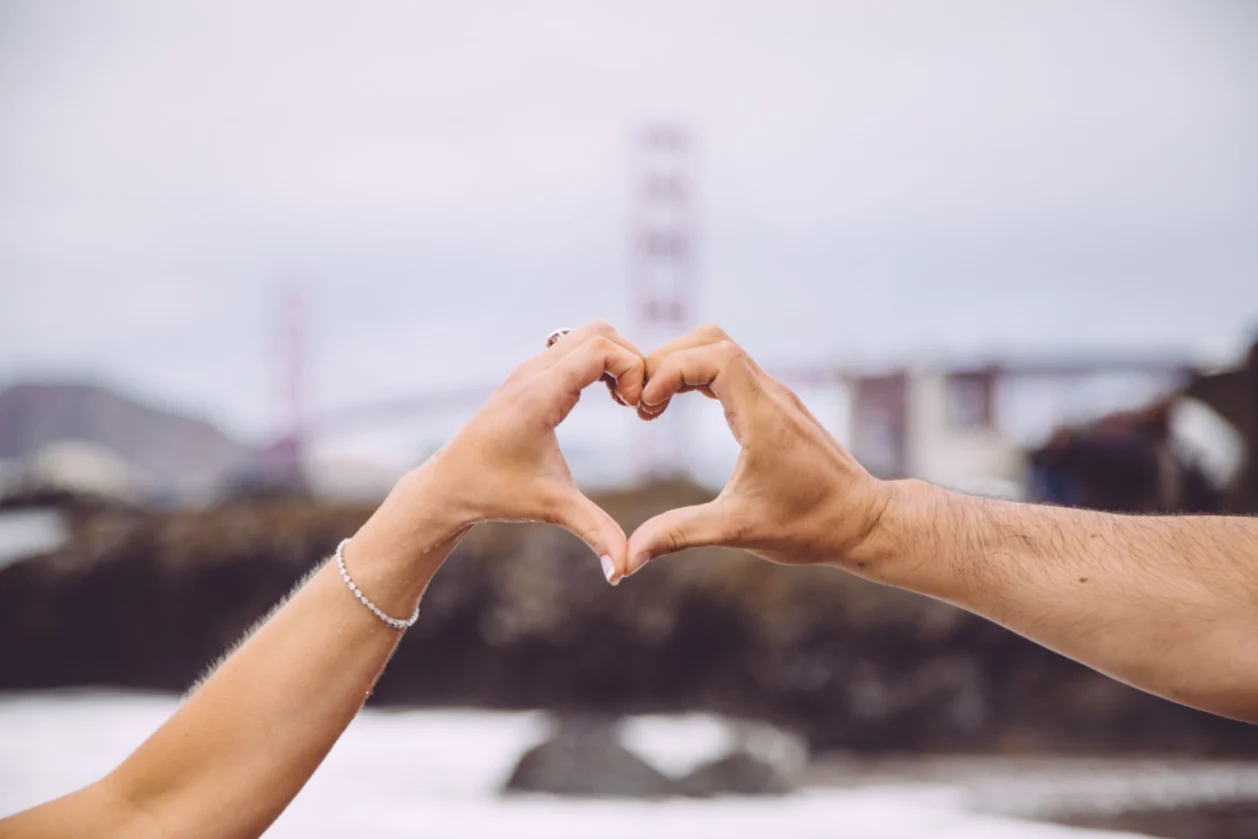 couple making heart shape with hands
